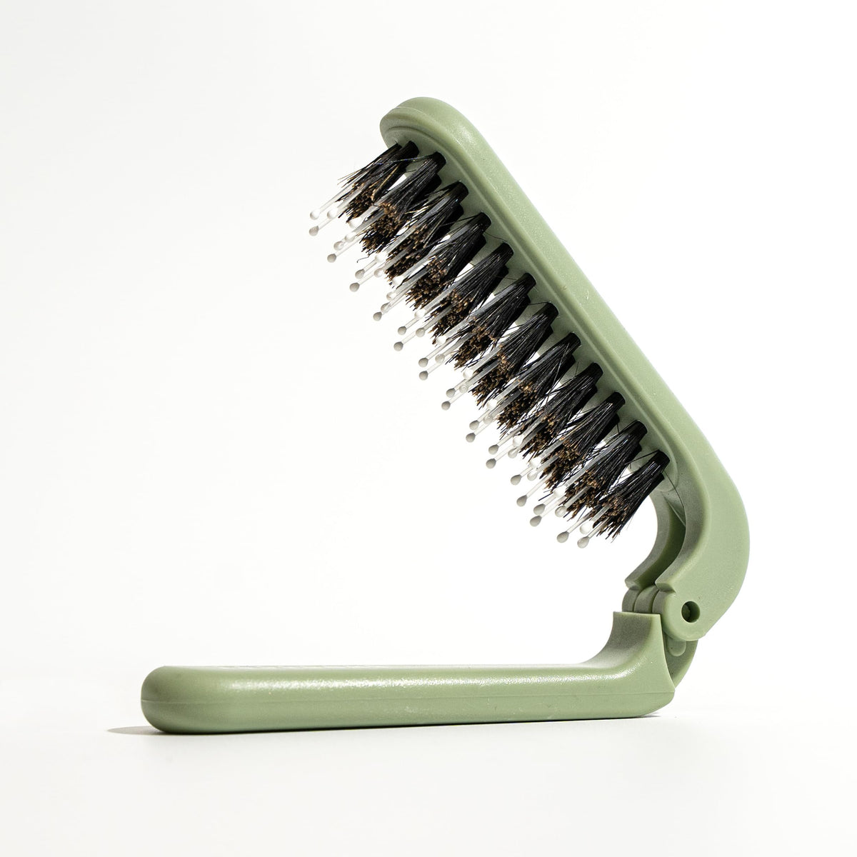Uffy MiniPop Travel Hair Brush foldable boar bristles for on-the-go detangling.