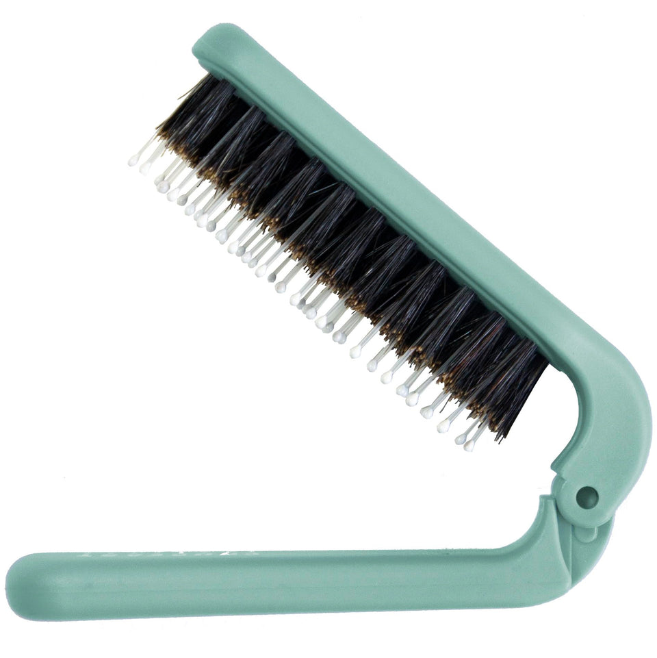 Uffy MiniPop folding brush close-up showing compact purse-ready design for easy on-the-go detangling
