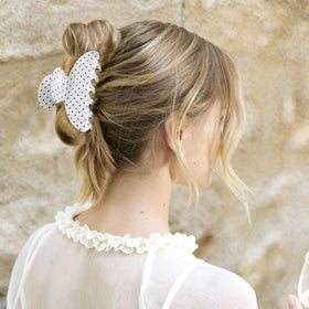 Unbednigt polka-dot black and white clip adds retro charm while keeping hair in place.
