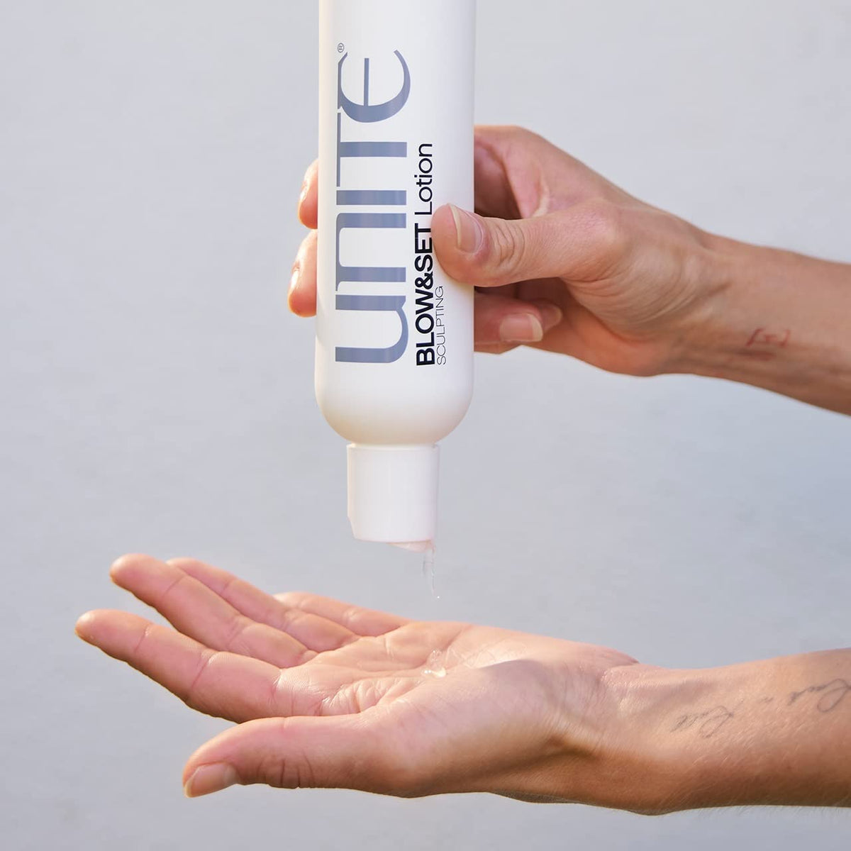 Close-up of heat styling with UNITE BLOW&SET offering UV protection