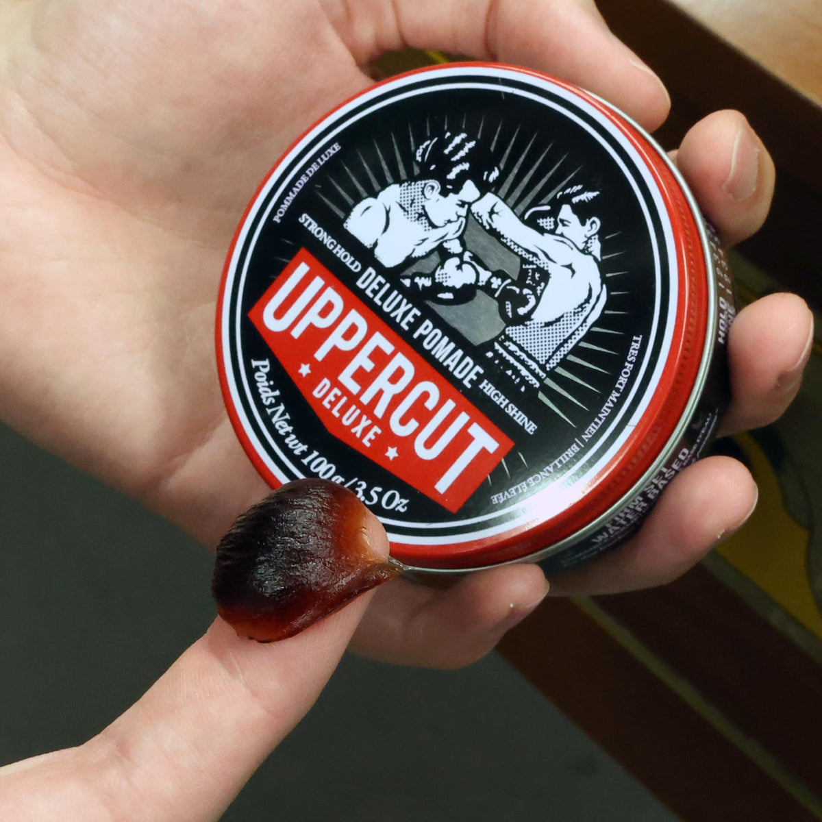 Styling with a comb to form a clean side part using Deluxe Pomade