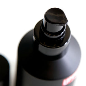 Close-up of balm being applied through beard for even distribution by Uppercut Deluxe.
