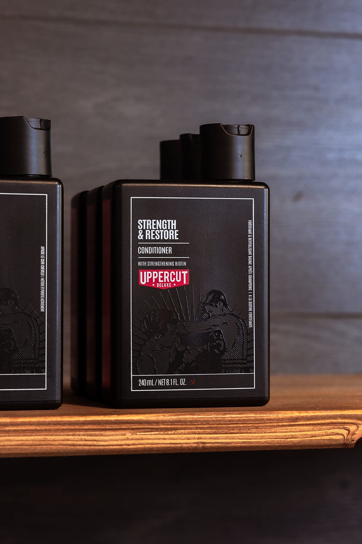 Uppercut Deluxe Strength & Restore on bathroom shelf with other grooming products