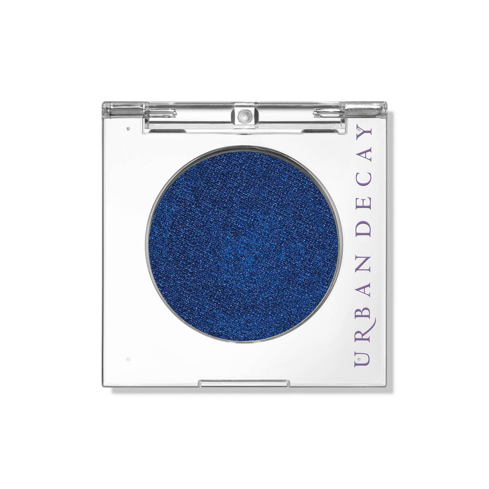 Urban Decay Charged compact swatch shows deep blue shimmer for bold evening wear.