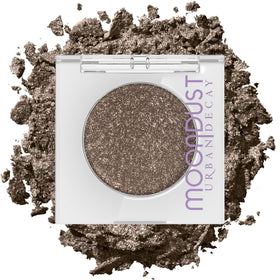 Urban Decay Moondust Space Cowboy compact close-up showing champagne-gold sparkle for luminous lids