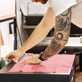 Urknall pink dental bibs protect your workspace and clothing.