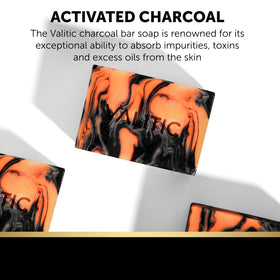VALITIC charcoal kojic turmeric bar slice reveals textured surface.