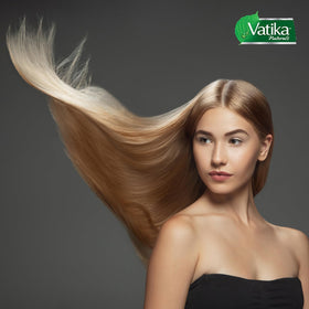Vatika Naturals packaging beside cactus and garlic ingredients suggests healthier-looking hair.