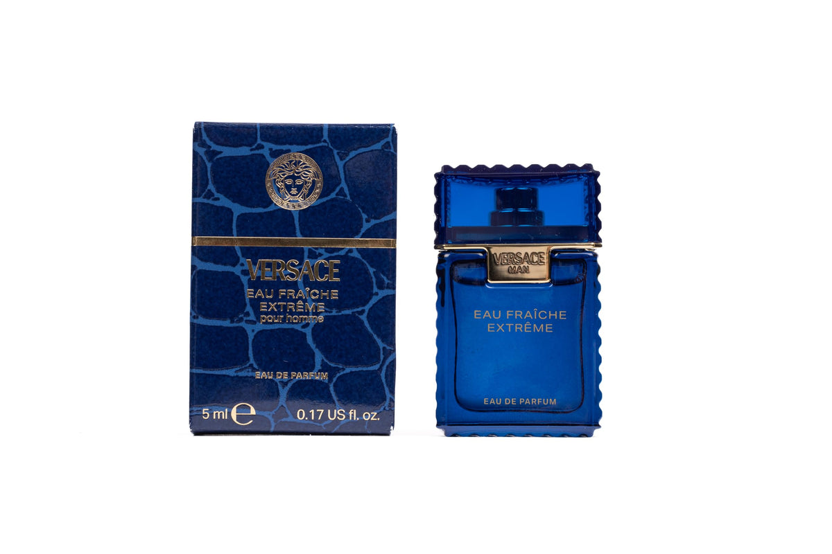 Versace Eau Fraiche Extreme mini on matte surface ideal for travel storage.