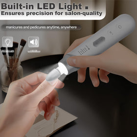 VFD cordless nail drill in hand demonstrates ergonomic, portable design for at-home manicures.