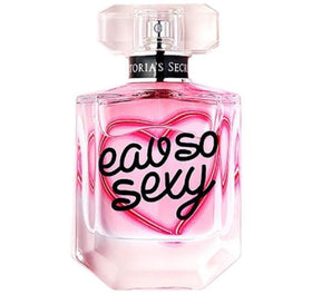 Glass bottle resting on soft fabric suggests everyday luxury and comfort.