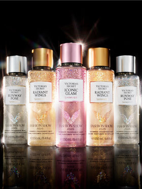 Victoria's Secret Fashion Show vibe as model walks with shimmer mist on skin