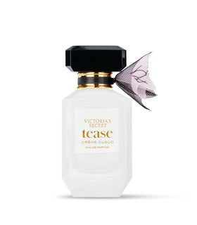 Victoria's Secret Tease Creme Cloud bottle with amber glow emphasizing sheer warmth.