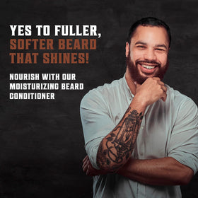 Hands applying conditioner to beard to show even distribution.