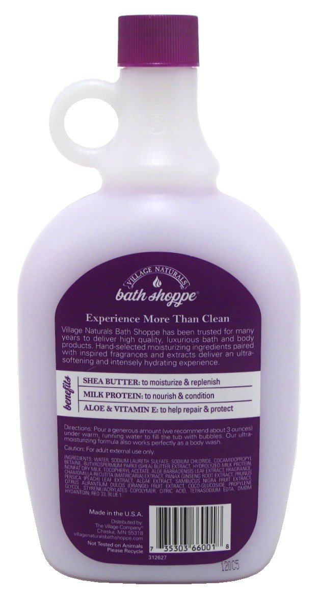 Village Naturals Therapy bath milk bottle close-up shows creamy texture and moisturizing ingredients