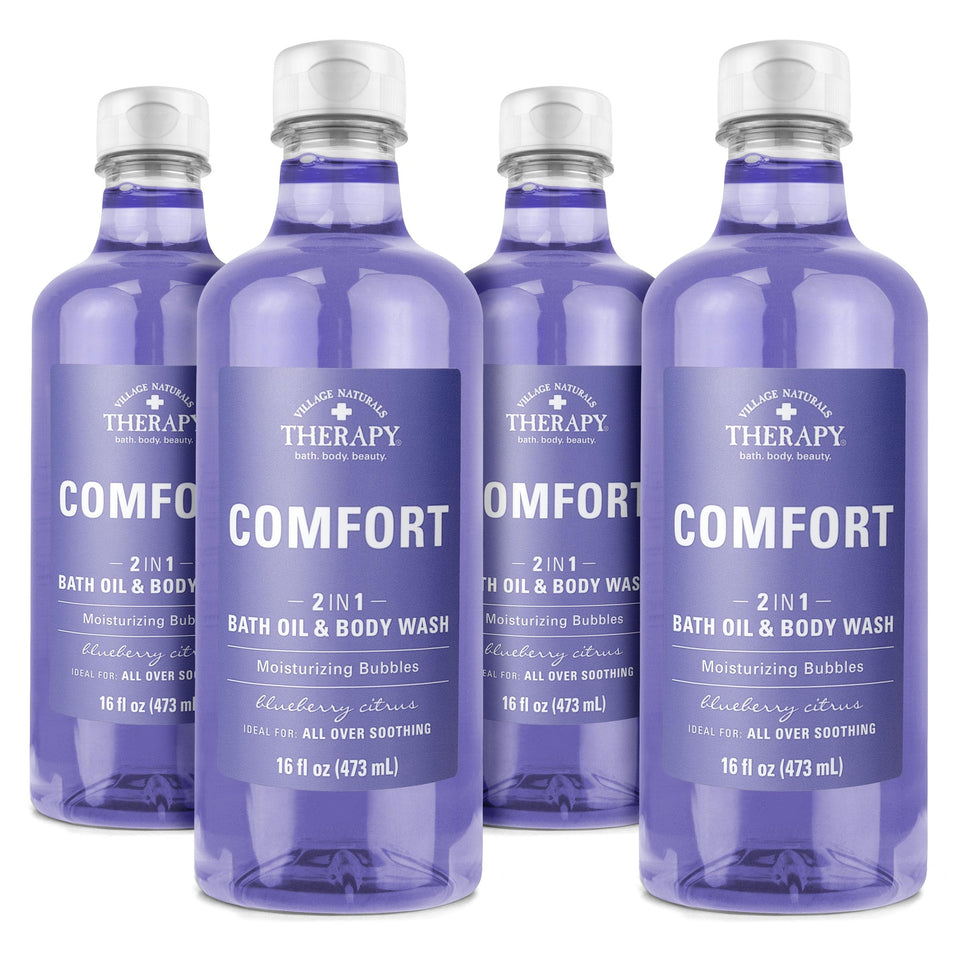 Village Naturals Therapy Comfort bath oil bottle front showing arnica and blueberry extracts for skin care