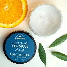 Village Naturals Therapy relaxing bath scene with bubbles and minty aroma.