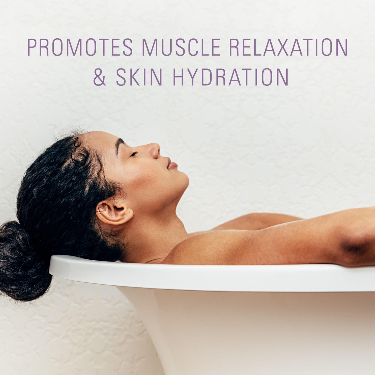 Spa-like tub scene with Village Naturals Therapy Calm flakes dissolving.