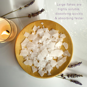 Village Naturals Therapy Calm flakes with jojoba oil for skin nourishment.