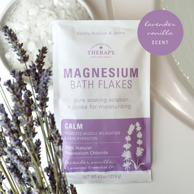 Pour Village Naturals Therapy Calm Flakes into water for a relaxing bath.