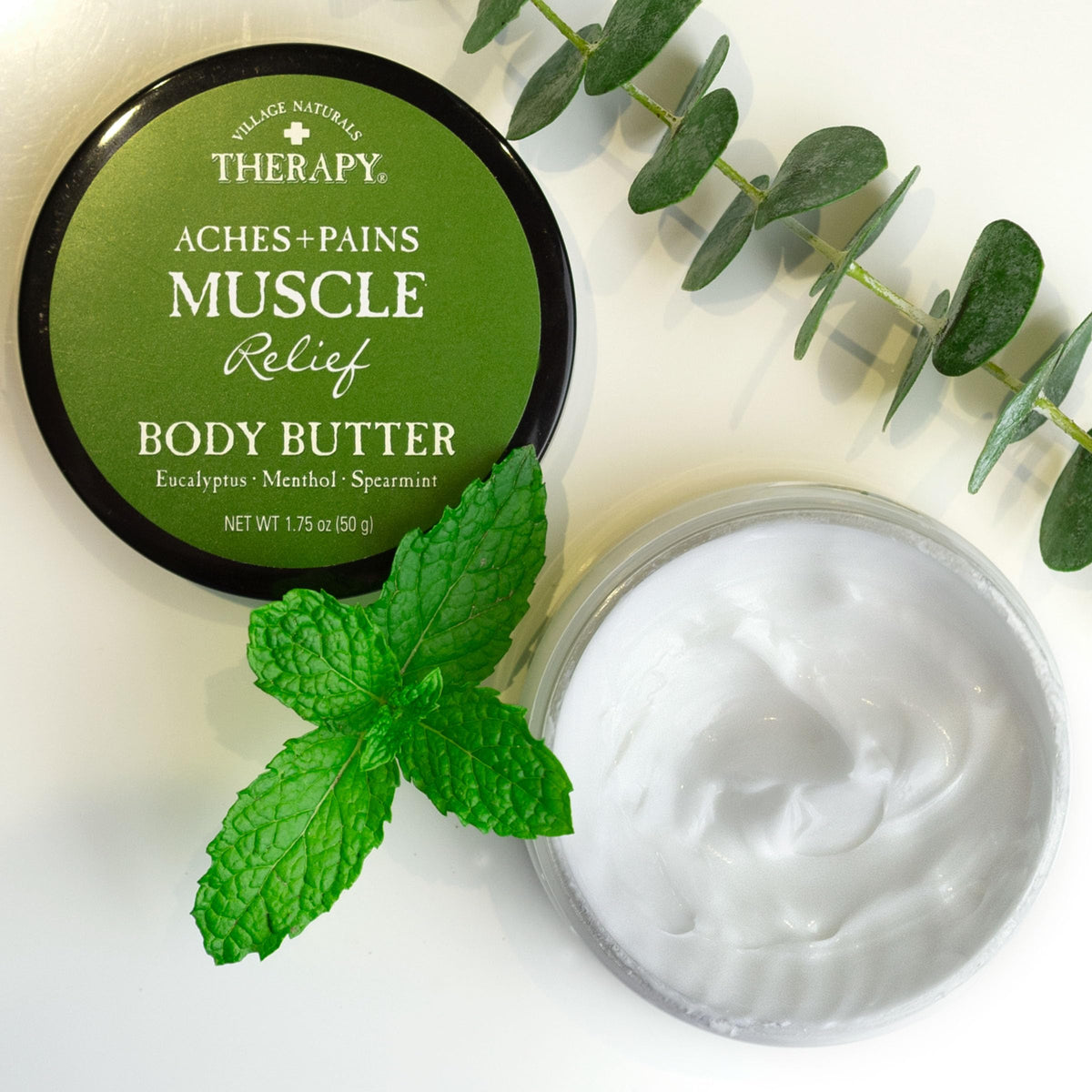 Close-up of Village Naturals Therapy label highlighting eucalyptus and mint notes.