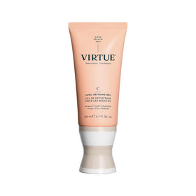 VIRTUE Curl Gel bottle dispensing the formula for easy styling and hold.