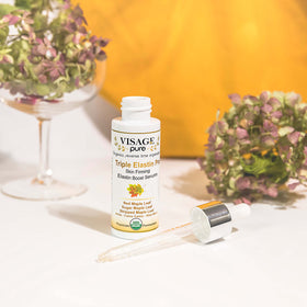 Visage Pure serum close-up bottle shines with premium quality and texture for daily care.
