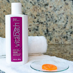 Vitabath Plus bottle closeup showing rich foam and creamy cleanse.