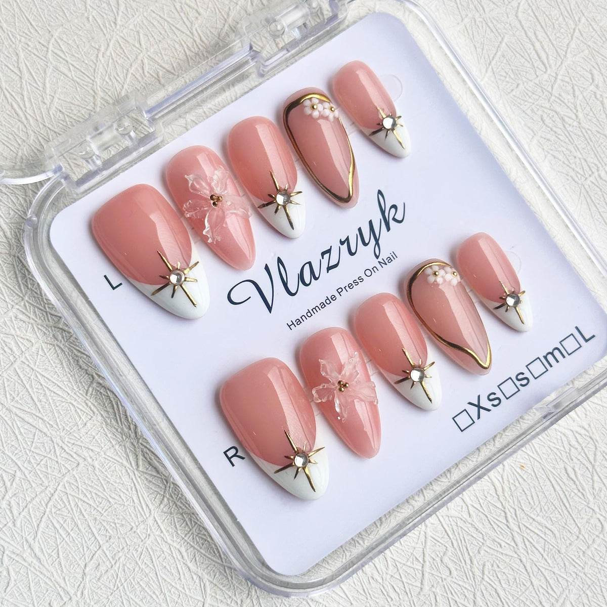 Vlazryk Brown French Tip nails with 3D metallic rhinestones for a glam look