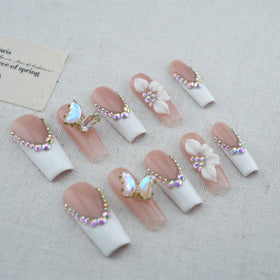 Vlazryk floral and butterfly nail art close-up highlighting unique designs and celebration-ready style.