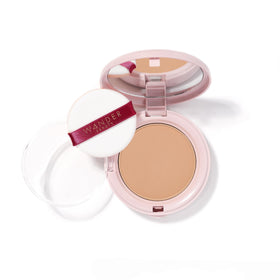 Wander Beauty Wanderlust Powder Foundation Golden Medium jar closeup shows hydrated, blurred skin.