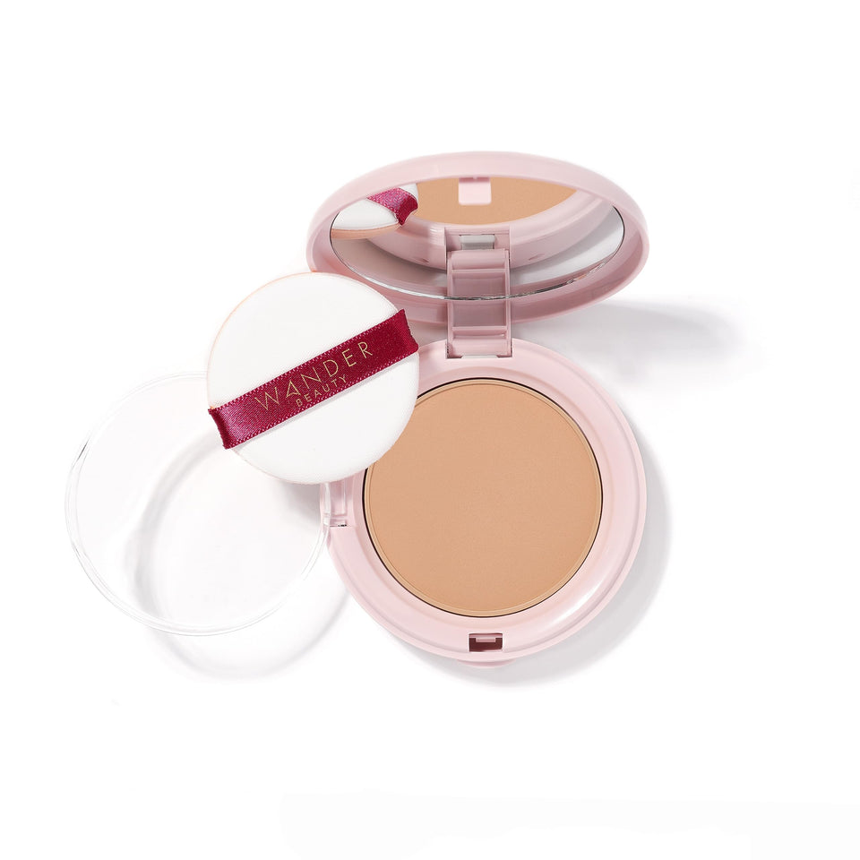 Wander Beauty Wanderlust Powder Foundation Golden Medium jar closeup shows hydrated, blurred skin.