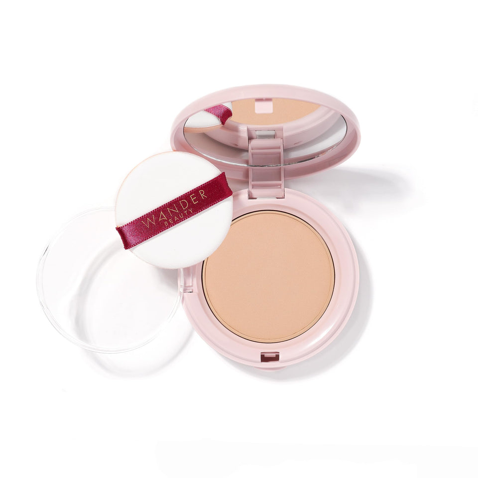 Wander Beauty Wanderlust Powder Foundation bottle close-up shows a hydrated, natural finish.