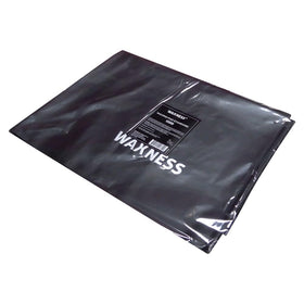 Waxness reusable pad in use during a professional waxing treatment.