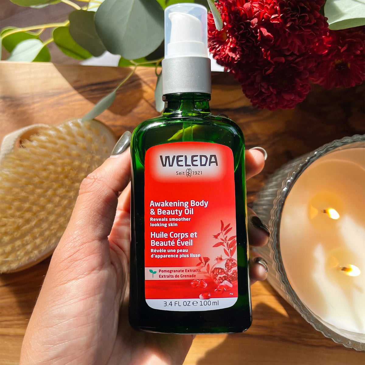 Weleda Awakening Pomegranate packaging features a sustainable blue glass bottle.