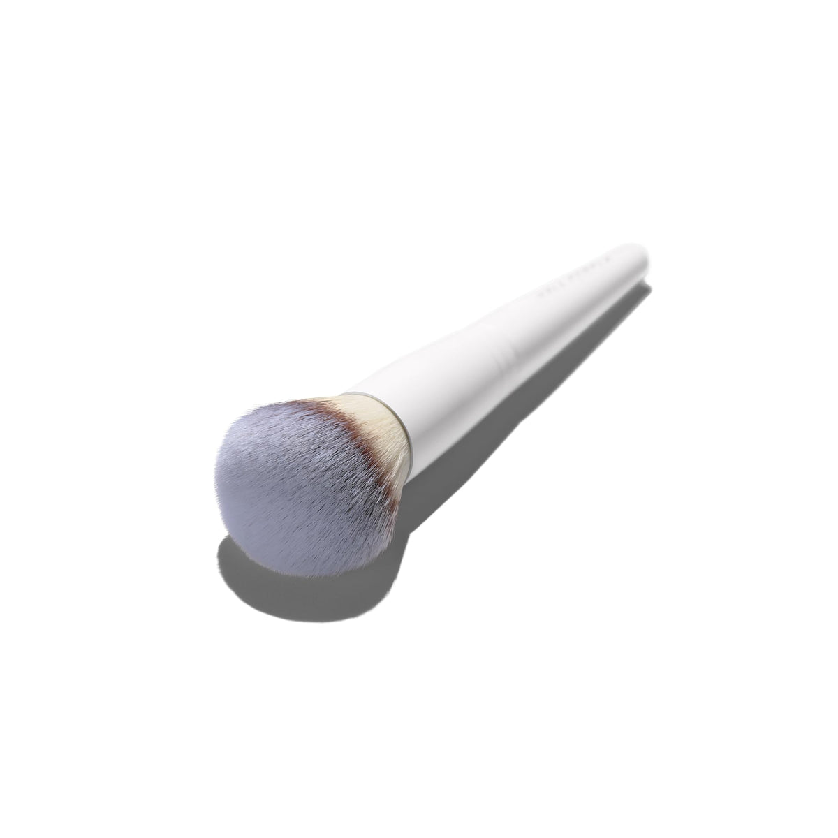 Well People Buffing Brush blending cream for even coverage.
