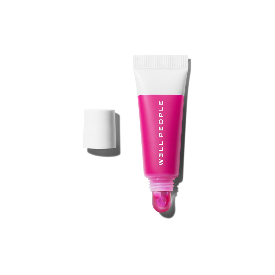 Well People Poutlove peptide lip balm tube showing sheer hydration and shine.