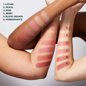 Well People Supernatural Stick blush tube in hand shows creamy formula for easy blending.