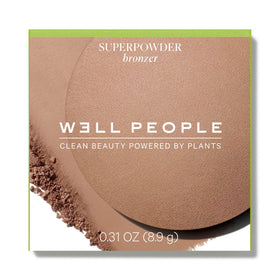 Well People Superpowder Bronzing Powder soft-focus finish close-up on skin.