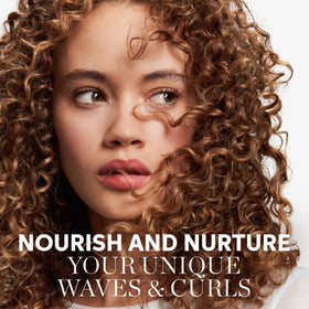 Wella Nutricurls Shampoo for Waves applying on hair for even distribution