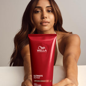 Wella Professionals logo and ULTIMATE REPAIR bottle in lifestyle shot