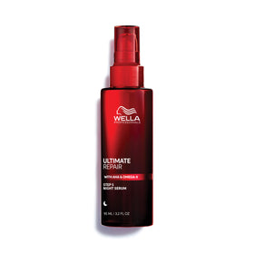 Wella Professionals ULTIMATE REPAIR Night Serum bottle on vanity, protecting hair during sleep.