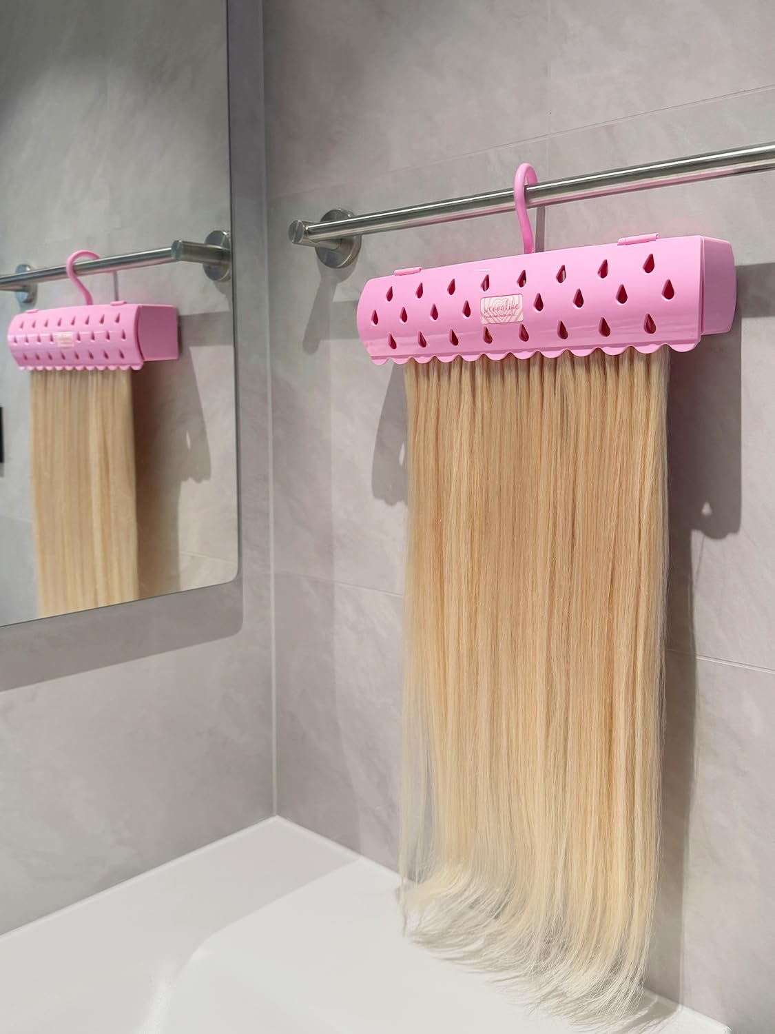 WENNALIFE hair extension holder top view with pink finish and organized wefts.