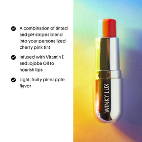 Winky Lux Rainbow Lip Balm bottle close-up highlighting jojoba oil and moisture