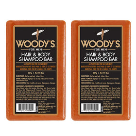 Woody's Hair & Body Bar for Men in hand, compact travel-friendly cleansing.