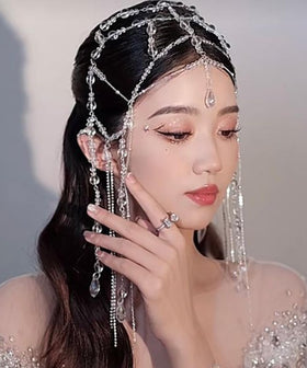 Xerling headpiece side detail showing tassel cap and rhinestones for evening wear