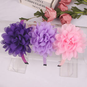 XIMA headbands for baby girls brighten hairstyles with a delicate flower.