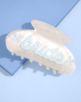 xo Fetti Bride Claw Clip set against wedding setup for refined styling.