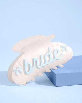 xo Fetti Bride Claw Clip shows blue bows and pearl details on marble acrylic.