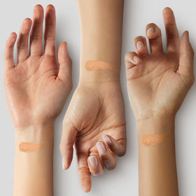 Brush applying YENSA foundation for seamless full-coverage blend.